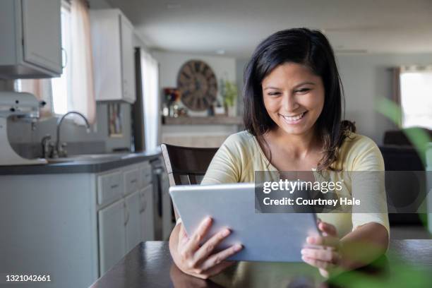 woman is using digital tablet and telecommuting or online shopping - daily life in philippines stock pictures, royalty-free photos & images
