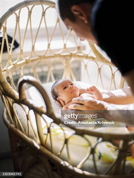 newborn baby girl lying in fathers hands. - fashionable dad stock pictures, royalty-free photos & images