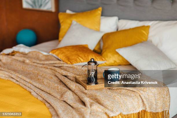 wood tray with tea on orange bed. - bedding foto e immagini stock