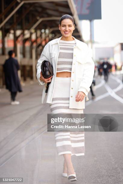 Tahnee Atkinson wearing Bally white knit top and skirt, Dion Lee jacket and Furla shoes at Afterpay Australian Fashion Week 2021 on June 01, 2021 in...