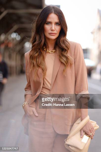 Jodi Anasta wearing gold necklace, pastel peach suit and bag from Oroton at Afterpay Australian Fashion Week 2021 on June 01, 2021 in Sydney,...