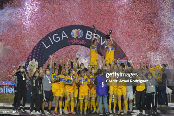 Players of Tigres celebrate with the trophy after winning the Final second leg match between Tigres UANL and Chivas as part of the Torneo Guard1anes...