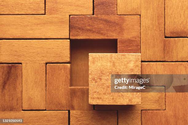 wooden puzzle with a missing piece - end to end solution stock pictures, royalty-free photos & images