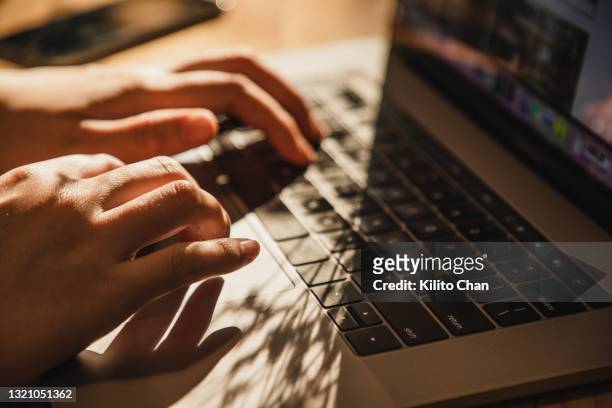 closeup of female hand typing using laptop - touchpad foto e immagini stock