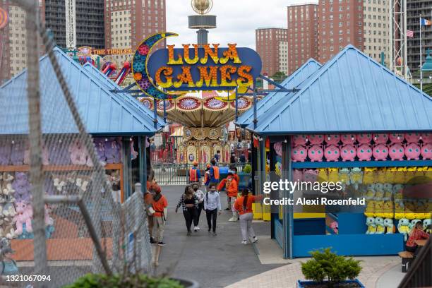 People walk through Luna Park at Coney Island on Memorial Day in the Brooklyn Borough of New York on May 31, 2021 in New York City. On May 19,...