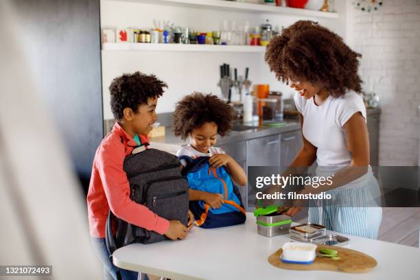 mother making school lunch - sack lunch stock pictures, royalty-free photos & images