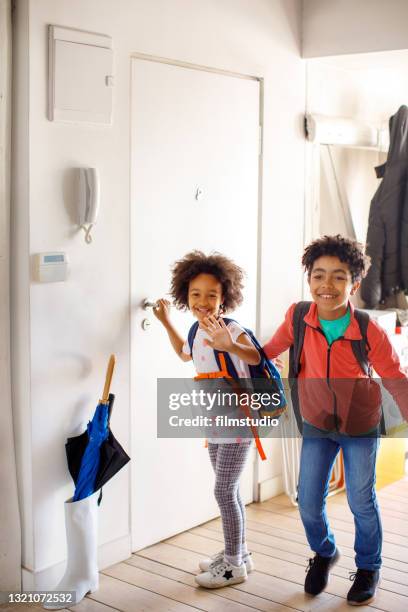 excited children returning home from school - röra mot bildbanksfoton och bilder