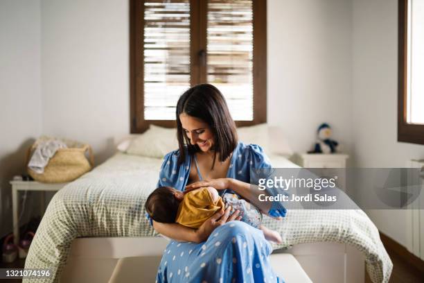 mother breast feeding baby - old life new life stock pictures, royalty-free photos & images