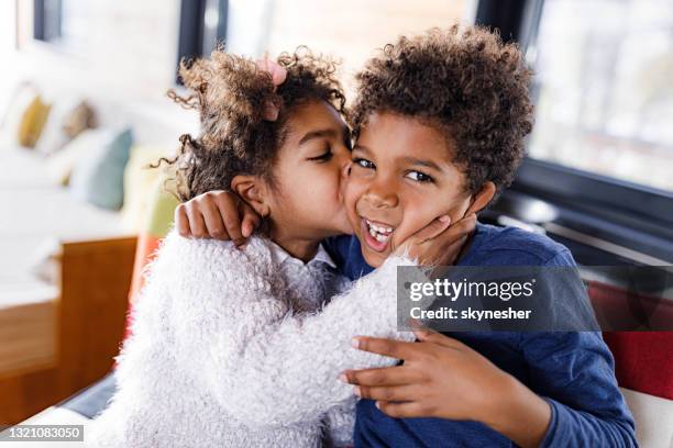 a kiss for my dearest brother! - kiss sisters stock pictures, royalty-free photos & images