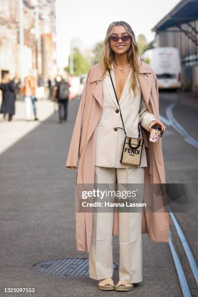 Sammy Robinson wearing Fendi bag, beige suit, pastel trench coat and espadrilles at Afterpay Australian Fashion Week 2021 on June 01, 2021 in Sydney,...