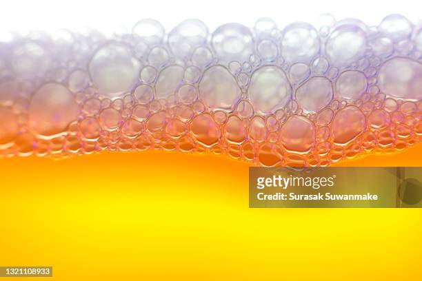 capture pure water moving through beautiful short colored glass. - beer white background stock pictures, royalty-free photos & images