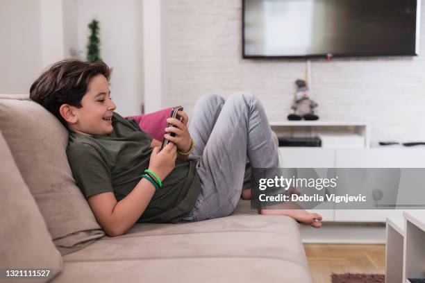 happy kid using smart phone at home - smart home cartoon stock pictures, royalty-free photos & images