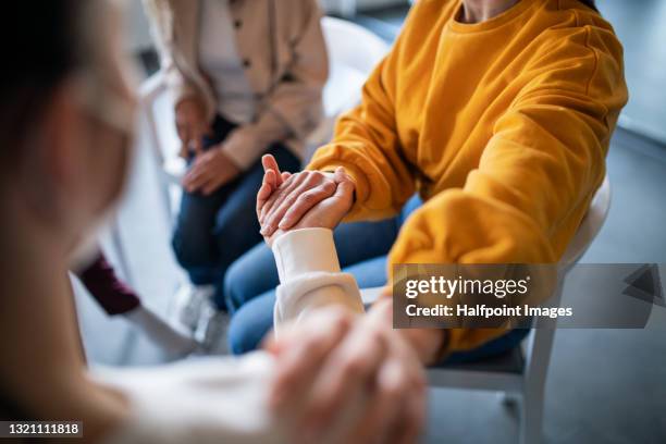 unrecognizable depressed woman on group therapy, counselling concept. - sostener fotografías e imágenes de stock