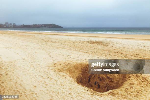 big hole on the beach - hole ストックフォトと画像