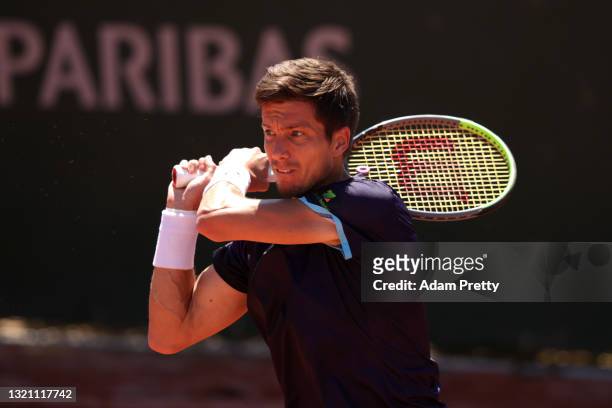 Aljaz Bedene of Slovenia plays a backhand in their mens first round match against Adrian Mannarino of France during day three of the 2021 French Open...