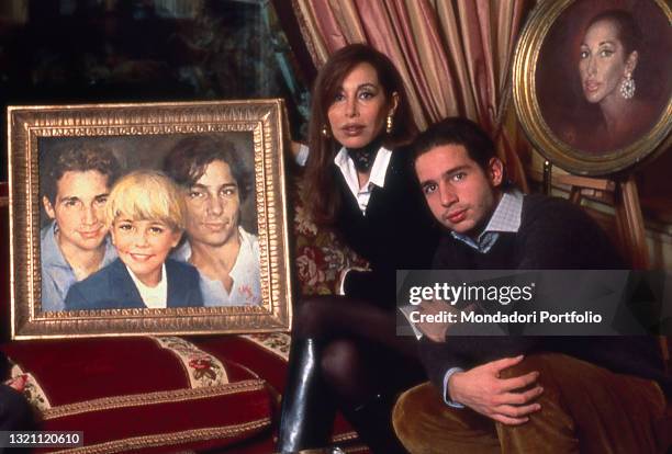 Daniela Zuccoli, wife of the Italian TV presenter Mike Bongiorno, posing in her house with her son Nicolò Bongiorno, next to some family portraits....