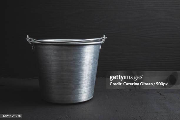 close-up of container on table against wall - metal bucket photos et images de collection