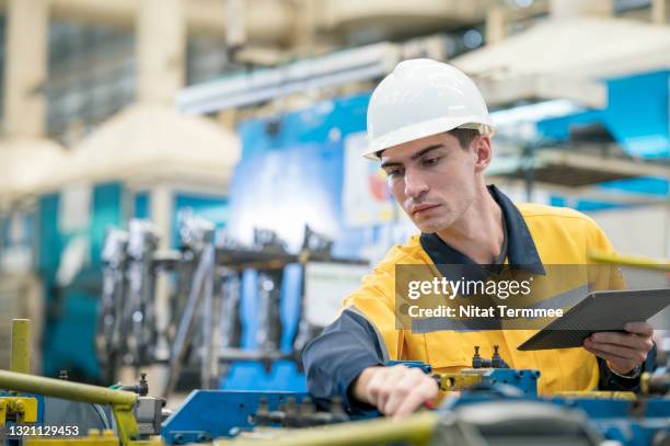 design engineer inspecting measurement or welding jig for auto parts in production line shopfloor. quality control assurance in auto part industry. - controle de qualidade imagens e fotografias de stock