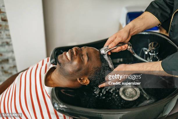 i like my hair clean - afro man washing stock pictures, royalty-free photos & images