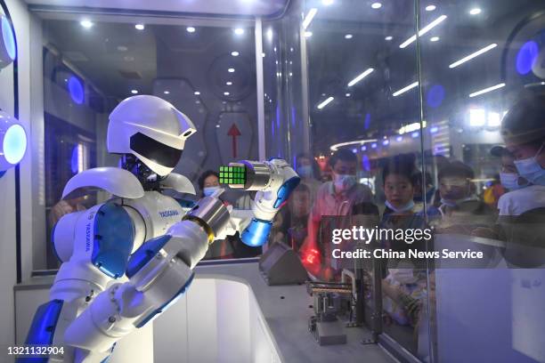 Yaskawa robot performs with Rubik's Cube for children at Sichuan Science and Technology Museum on the International Children's Day on June 1, 2021 in...