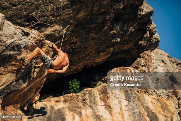 male solo rock climber, reaching the heights while taking care of his safety thoughtfully taking the next step - soloing stock pictures, royalty-free photos & images