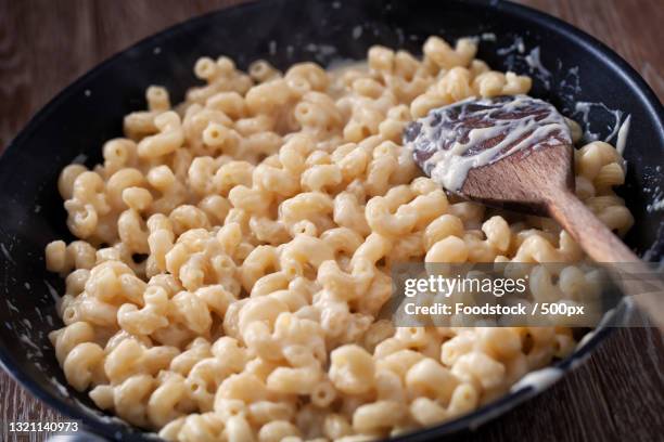 close-up of food in bowl on table - macaroni and cheese stock pictures, royalty-free photos & images