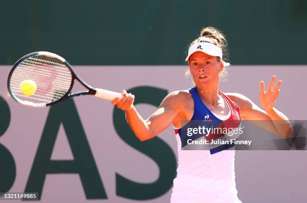 Chloe Paquet of France plays a forehand in their ladies first round match against Magda Linette of Poland during day three of the 2021 French Open at...