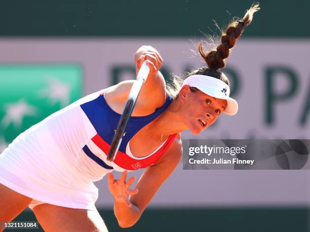 Chloe Paquet of France serves in their ladies first round match against Magda Linette of Poland during day three of the 2021 French Open at Roland...