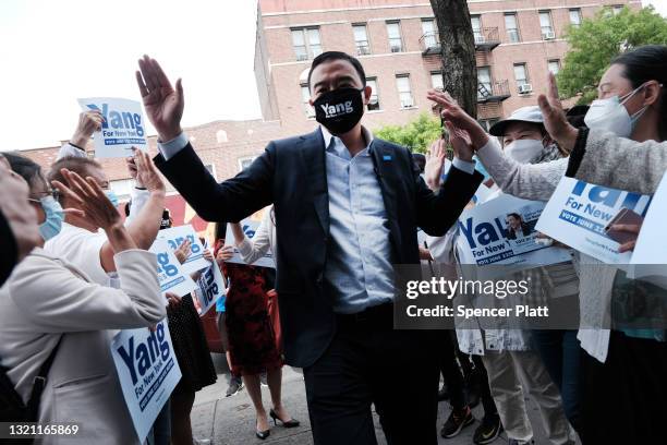 New York City Mayoral candidate Andrew Yang stands with his wife Evelyn Yang as greets supporters at the opening of a new campaign office in Brooklyn...