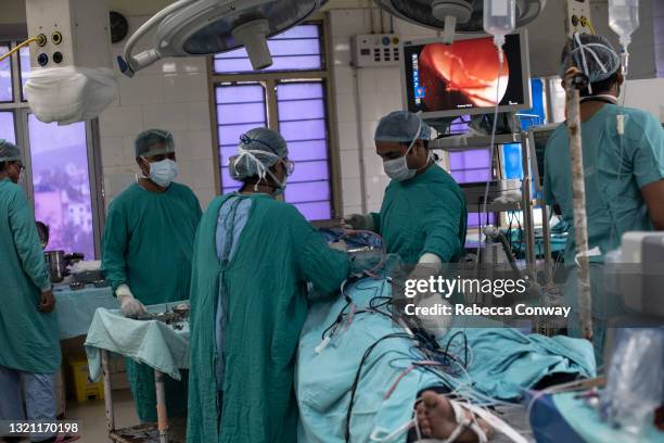 Indian surgeons Antima Memiwal and Kailash Singh Jat perform an endoscopic surgery to remove a fungal infection from a patient suffering from...