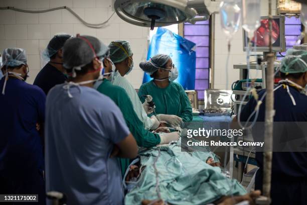 An Indian surgical team performs an endoscopic surgery to remove a fungal infection from a patient suffering from mucormycosis at the Sawai Man Singh...