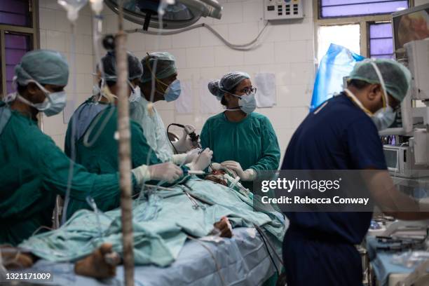 An Indian surgical team performs an endoscopic surgery to remove a fungal infection from a patient suffering from mucormycosis at the Sawai Man Singh...