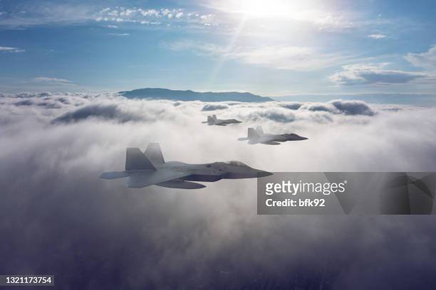 jet fighters flying over the clouds. - air force operations stock pictures, royalty-free photos & images