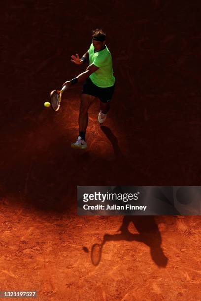 Rafael Nadal of Spain plays a forehand in his mens first round match against Alexei Popyrin of Australia during day three of the 2021 French Open at...