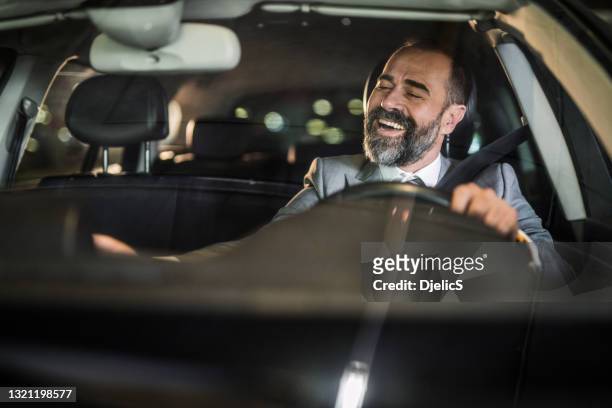 businessman driving a car. - car listening to music imagens e fotografias de stock