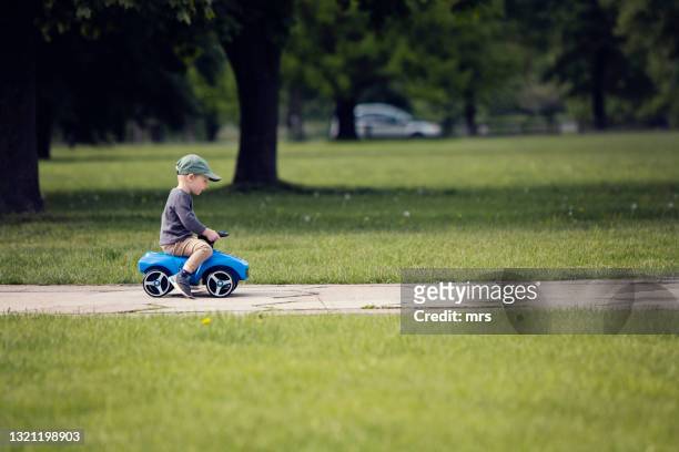 little boy driving his toy car - toy car foto e immagini stock