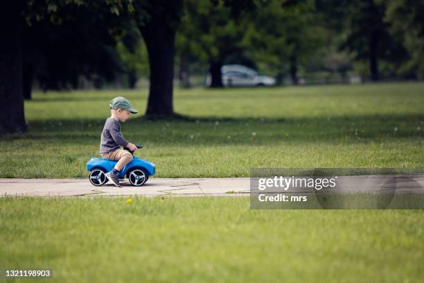 little boy driving his toy car - toy car stock pictures, royalty-free photos & images