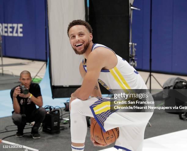 Stephen Curry smiles up at Zaza Pachulia after seeing him at media day for the Golden State Warriors at Chase Arena in San Francisco, Calif., on...