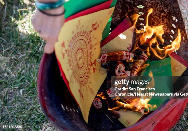 Alice Lai-Bitker burns paper symbolizing money as her and her family participate in a Chinese tomb sweeping holiday for writer Janelle Biker's late...