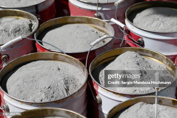 buckets of powdered cement ready to be used in a construction site - cement factory stock pictures, royalty-free photos & images