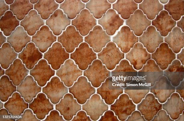 glazed mottled brown scalloped diamond shaped tiles on a building exterior wall - scalloped pattern stock pictures, royalty-free photos & images