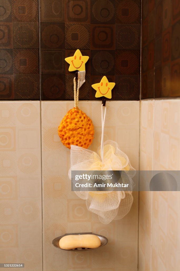Body bath scrubbers (Loofah) hanging and soap holder in a bathroom.