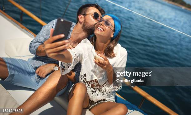 young couple on a sailing cruise. - happy woman sailing stock pictures, royalty-free photos & images