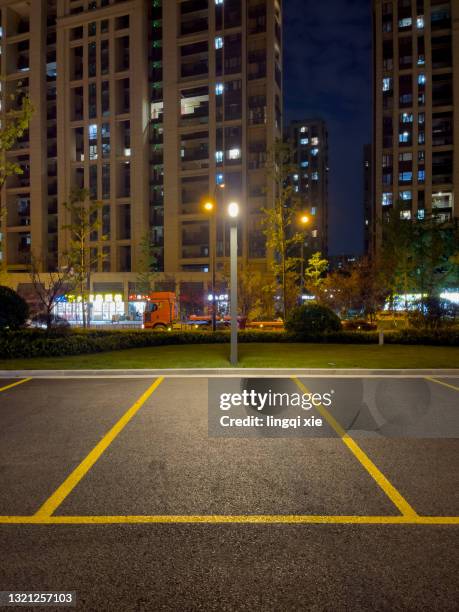 night of the parking lot on the street lights and parking spaces - parking space stock pictures, royalty-free photos & images