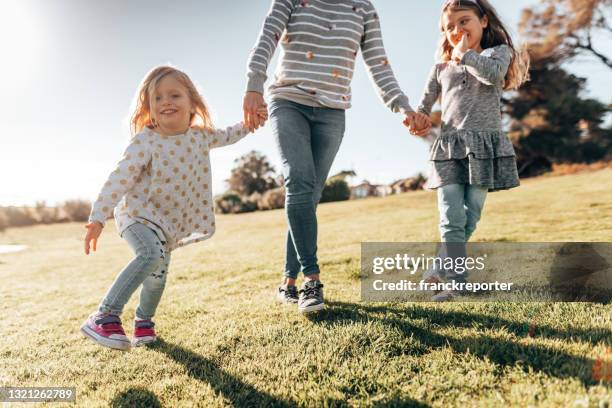 mother holding hands with the daughter - family with two children stock pictures, royalty-free photos & images