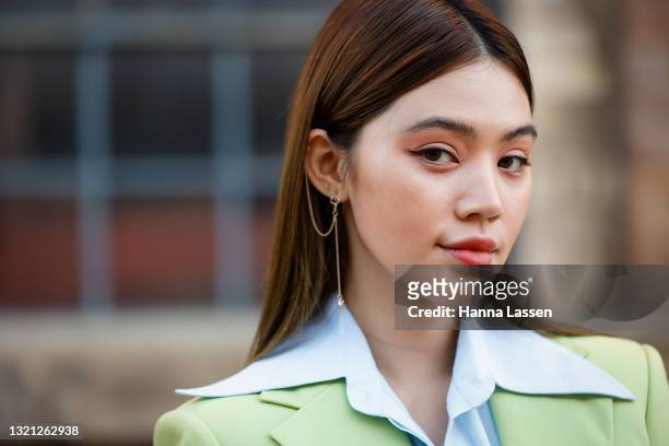 Jolie Nguyen wearing Nudie Eye green cropped suit, Prada pink bag and Bottega Veneta shoes at Afterpay Australian Fashion Week 2021 on June 02, 2021...