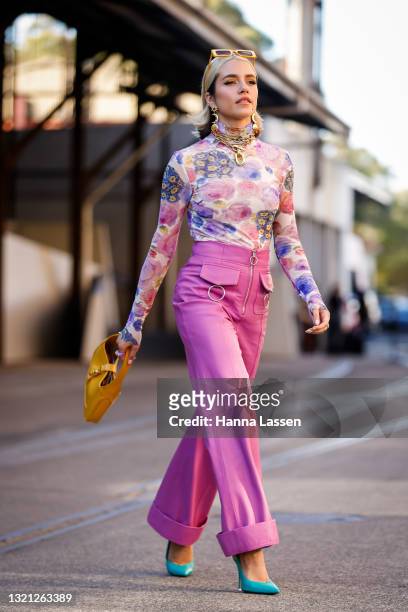 Maxine Wylde wearing Gann top, Paco Rabanne, Mountain and Moon earrings, Cult Gaia sunglasses, Alice McCall pants, The Attico shoes and Gucci bag at...