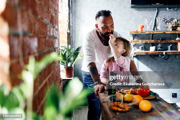 daughter cuts vegetables and treats my dad. - kid chef stock pictures, royalty-free photos & images