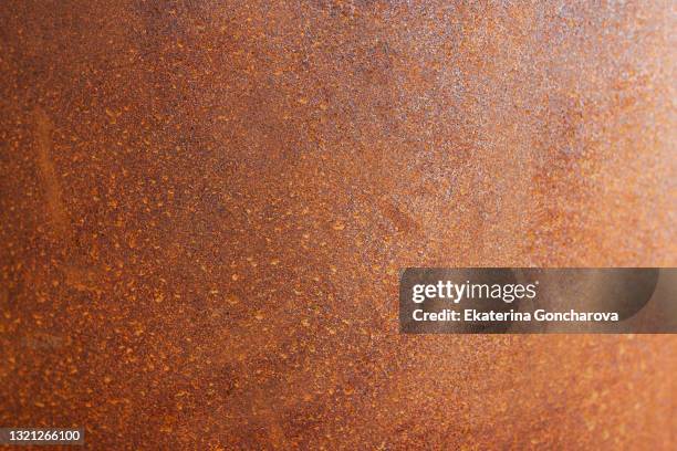 the background is made of a rusty metal surface. trendy background in the style of grunge - copper foto e immagini stock