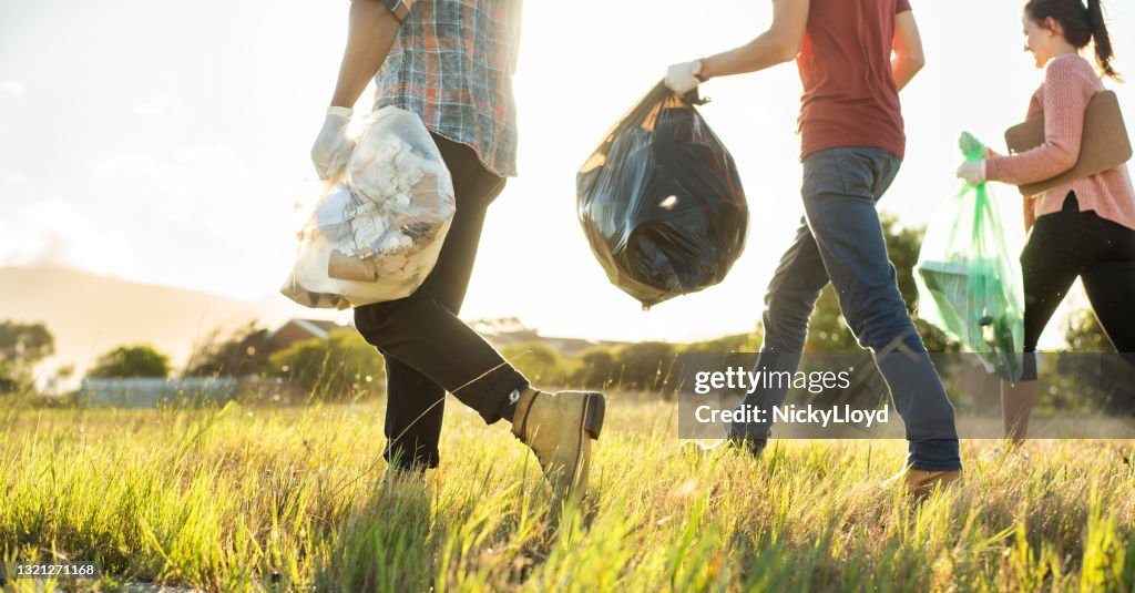 Young volunteers walking in a field during a cleanup day